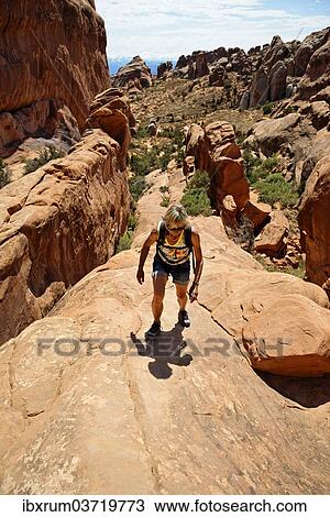 "Hiker on a cliff in Devil's Garden, formed by the erosion of sandstone, Arches-Nationalpark, near Moab, Utah, United States, North America" View Large Photo Image Stock Image - "Hiker on a cliff in Devil's Garden, formed by the erosion of sandstone, Arches-Nationalpark, near Moab, Utah, United States, North America". Fotosearch