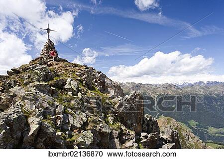 "Hiker on the summit of Spitzen Kornigls Mountain, overlooking the Val d'Ultimo, Ultimo, Alto Adige, Italy, Europe" View Large Photo Image Stock Image - "Hiker on the summit of Spitzen Kornigls Mountain, overlooking the Val d'Ultimo, Ultimo, Alto Adige, Italy, Europe". Fotosearch
