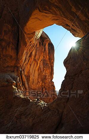 "Hiker relaxing under the Double Arch, stone arches of red sandstone formed by erosion, Arches-Nationalpark, near Moab, Utah, United States, North America" View Large Photo Image Stock Photography - "Hiker relaxing under the Double Arch, stone arches of red sandstone formed by erosion, Arches-Nationalpark, near Moab, Utah, United States, North America". Fotosearch