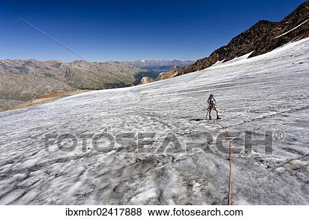 "Hiker walking on Hohenferner mountain, climbing to the peak of Cima Venezia mountain, Martell valley at the back, province of Bolzano-Bozen, Italy, Europe" View Large Photo Image Stock Photo - "Hiker walking on Hohenferner mountain, climbing to the peak of Cima Venezia mountain, Martell valley at the back, province of Bolzano-Bozen, Italy, Europe". Fotosearch