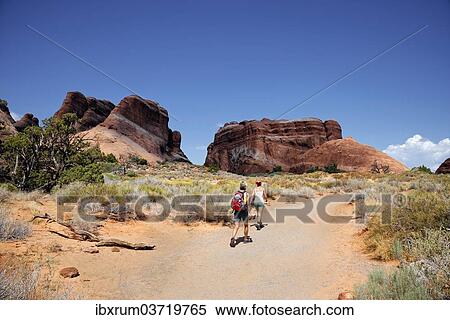 "Hikers on a trail in Devil's Garden with sandstone cliffs formed by erosion, Arches-Nationalpark, Devils Garden, Moab, Utah, United States, North America" View Large Photo Image Stock Photography - "Hikers on a trail in Devil's Garden with sandstone cliffs formed by erosion, Arches-Nationalpark, Devils Garden, Moab, Utah, United States, North America". Fotosearch
