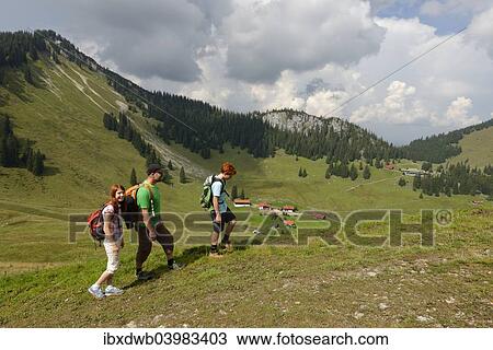 "Hikers on Sutten mountain in the Suttenregion, in front of Lower and Upper Firstalm, in front of Bodenschneid mountain, Upper Bavaria, Bavaria, Germany, Europe" View Large Photo Image Stock Image - "Hikers on Sutten mountain in the Suttenregion, in front of Lower and Upper Firstalm, in front of Bodenschneid mountain, Upper Bavaria, Bavaria, Germany, Europe". Fotosearch