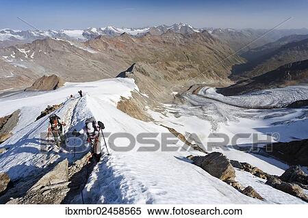"Hikers on the summit ridge ascending to Similaun on Niederjochferner Mountain in Val Senales valley, view towards Marzell Ridge, Alto Adige, Italy, Europe" View Large Photo Image Stock Photography - "Hikers on the summit ridge ascending to Similaun on Niederjochferner Mountain in Val Senales valley, view towards Marzell Ridge, Alto Adige, Italy, Europe". Fotosearch