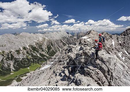 "Hikers on the summit ridge during the ascent through the Imster via ferrata on the Maldonkopf in the Lech Valley Alps, Hochimst, Imst, Tyrol, Austria, Europe" View Large Photo Image Stock Photography - "Hikers on the summit ridge during the ascent through the Imster via ferrata on the Maldonkopf in the Lech Valley Alps, Hochimst, Imst, Tyrol, Austria, Europe". Fotosearch