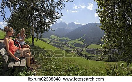 "Hikers resting above S. Magdalena on the Bergbauernweg trail, Villnoesstal valley, province of Bolzano-Bozen, Italy, Europe" View Large Photo Image Stock Photo - "Hikers resting above S. Magdalena on the Bergbauernweg trail, Villnoesstal valley, province of Bolzano-Bozen, Italy, Europe". Fotosearch