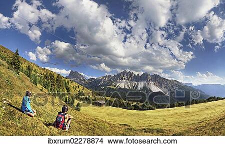 "Hikers sitting near Enzianhuette mountain lodge on Plosen mountain, enjoying the view of the Afer Geisler group and Peitlerkofel mountain, Wuerzjoch ridge, Villnoesstal valley, Dolomites, province of Bolzano-Bozen, Italy, Europe" View Large Photo Image Picture - "Hikers sitting near Enzianhuette mountain lodge on Plosen mountain, enjoying the view of the Afer Geisler group and Peitlerkofel mountain, Wuerzjoch ridge, Villnoesstal valley, Dolomites, province of Bolzano-Bozen, Italy, Europe". Fotosearch