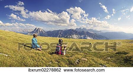 "Hikers sitting on the Aferer Alm alp on Plosen mountain, enjoying the view of the Afer Geisler group and Peitlerkofel mountain, Wuerzjoch ridge, Villnoesstal valley, Dolomites, province of Bolzano-Bozen, Italy, Europe" View Large Photo Image Stock Image - "Hikers sitting on the Aferer Alm alp on Plosen mountain, enjoying the view of the Afer Geisler group and Peitlerkofel mountain, Wuerzjoch ridge, Villnoesstal valley, Dolomites, province of Bolzano-Bozen, Italy, Europe". Fotosearch