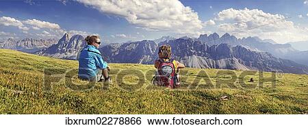 "Hikers sitting on the Aferer Alm alp on Plosen mountain, enjoying the view of the Afer Geisler group and Peitlerkofel mountain, Wuerzjoch ridge, Villnoesstal valley, Dolomites, province of Bolzano-Bozen, Italy, Europe" View Large Photo Image Stock Photograph - "Hikers sitting on the Aferer Alm alp on Plosen mountain, enjoying the view of the Afer Geisler group and Peitlerkofel mountain, Wuerzjoch ridge, Villnoesstal valley, Dolomites, province of Bolzano-Bozen, Italy, Europe". Fotosearch