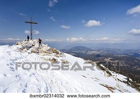Stock Image - "Hikers standing on the summit of Weisshorn mountain above Radein and the Bletterbachschlucht gorge, province of Bolzano-Bozen, Italy, Europe". Fotosearch