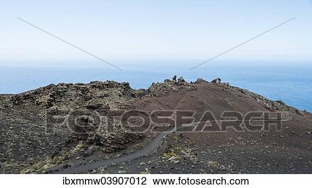 Stock Image - "Hiking trail through a lava landscape, Southern Cape, Punta de Fuencaliente, La Palma, Canary Islands, Spain, Europe". Fotosearch
