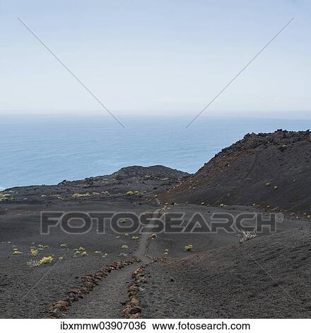 Stock Photograph - "Hiking trail through a lava landscape, Southern Cape, Punta de Fuencaliente, La Palma, Canary Islands, Spain, Europe". Fotosearch