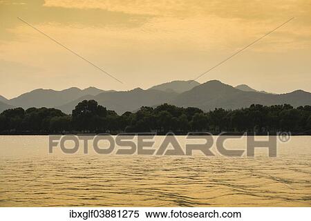 Stock Photography - "Hills at West Lake at sunset, Xihu, Hangzhou, Zhejiang Province, China, Asia". Fotosearch