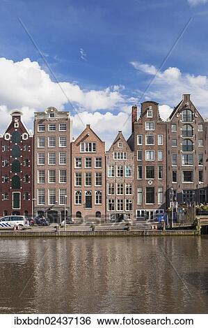 "Historic buildings along the Damrak canal in Amsterdam, Holland, Netherlands, Europe" View Large Photo Image Stock Photograph - "Historic buildings along the Damrak canal in Amsterdam, Holland, Netherlands, Europe". Fotosearch