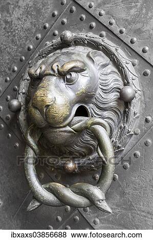 Stock Photo - "Historical door knocker, lion's head with two snakes in its mouth, historic centre, Dresden, Saxony, Germany, Europe". Fotosearch