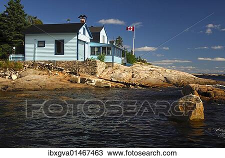 "Holiday houses along the rocky shore of the St. Lawrence River, Tadoussac, Canada, North America" View Large Photo Image Stock Image - "Holiday houses along the rocky shore of the St. Lawrence River, Tadoussac, Canada, North America". Fotosearch