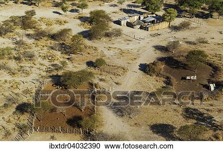 Stock Image - "Homesteads just outside of the protected area, aerial view, Okavango Delta, Botswana, Africa". Fotosearch