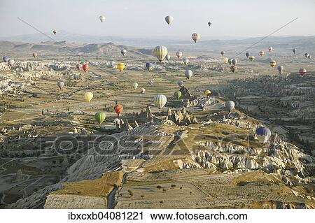 "Hot air balloons rising over the cave dwellings and tufa formations in the morning light, Nevsehir Province, Cappadocia, Anatolia, Turkey, Asia" View Large Photo Image Stock Image - "Hot air balloons rising over the cave dwellings and tufa formations in the morning light, Nevsehir Province, Cappadocia, Anatolia, Turkey, Asia". Fotosearch