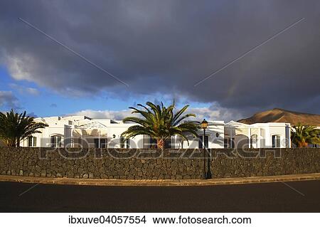 "Hotel and apartment complex in the evening light, typical white cottages behind a dry wall made of lava rocks, with Canary Island Date Palms (Phoenix canariensis), Playa Blanca, Lanzarote, Canary Islands, Spain, Europe" View Large Photo Image Picture - "Hotel and apartment complex in the evening light, typical white cottages behind a dry wall made of lava rocks, with Canary Island Date Palms (Phoenix canariensis), Playa Blanca, Lanzarote, Canary Islands, Spain, Europe". Fotosearch
