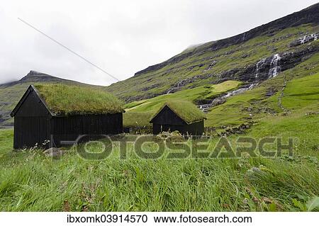 Stock Image - "Houses with grass roofs, sod houses, waterfall at the back, Saksun, Streymoy, Faroe Islands, Denmark, Europe". Fotosearch