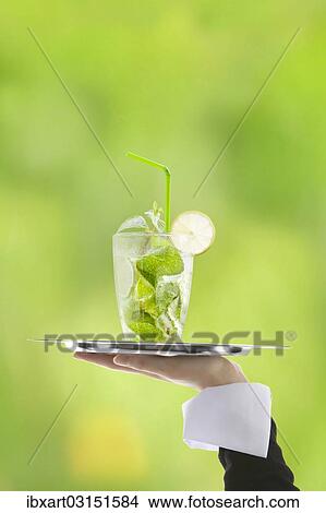 Picture - Hugo cocktail with lime and mint being served on a tray. Fotosearch