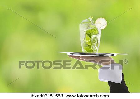 Stock Image - Hugo cocktail with lime and mint being served on a tray. Fotosearch