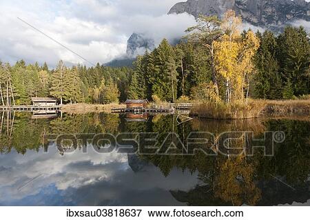 "Hut and trees in autumn reflected in the Volser Weiher lake, Schlern-Rosengarten Nature Park, South Tyrolean Dolomites, Vols am Schlern or Fie allo Sciliar, Schlern region, Alto Adige, Trentino-Alto Adige, Italy, Europe" View Large Photo Image Stock Photo - "Hut and trees in autumn reflected in the Volser Weiher lake, Schlern-Rosengarten Nature Park, South Tyrolean Dolomites, Vols am Schlern or Fie allo Sciliar, Schlern region, Alto Adige, Trentino-Alto Adige, Italy, Europe". Fotosearch