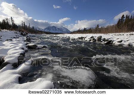 Stock Photography - "Ice, snow and water at freezing Quill Creek, St. Elias Mountains, Kluane Range behind, Kluane National Park and Reserve, Yukon Territory, Canada, North America". Fotosearch
