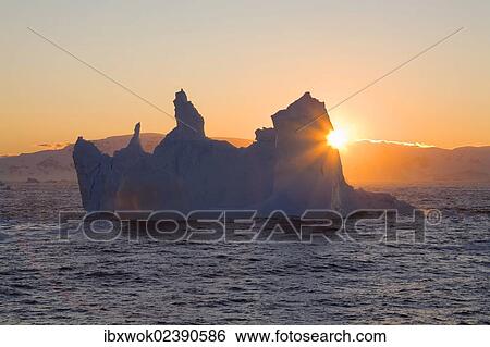 Stock Photograph - "Iceberg at sunrise on the southern polar circle, Antarctica". Fotosearch