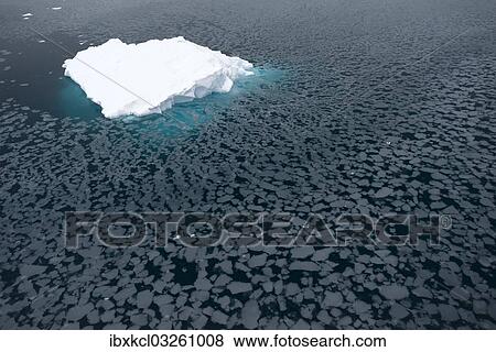 Stock Photo - "Iceberg surrounded by slush, Paradise Bay, Antarctic Peninsula, Antarctica". Fotosearch