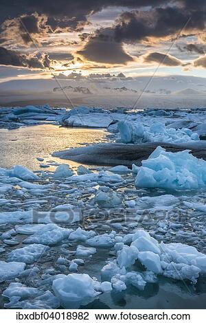 "Icebergs, dramatic clouds, glacier lagoon Jokulsarlon in the evening sun, Vatnajokull Glacier, Eastern Region, Iceland, Europe" View Large Photo Image Stock Image - "Icebergs, dramatic clouds, glacier lagoon Jokulsarlon in the evening sun, Vatnajokull Glacier, Eastern Region, Iceland, Europe". Fotosearch
