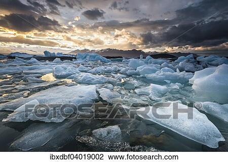 "Icebergs, dramatic clouds, Jokulsarlon glacial lagoon in the evening sun, Vatnajokull Glacier, East, Iceland, Europe" View Large Photo Image Stock Image - "Icebergs, dramatic clouds, Jokulsarlon glacial lagoon in the evening sun, Vatnajokull Glacier, East, Iceland, Europe". Fotosearch