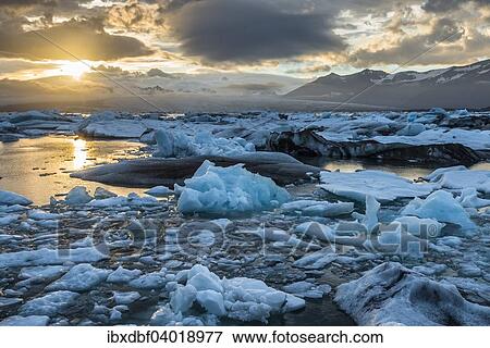 "Icebergs, pieces of ice, dramatic clouds, Jokulsarlon glacial lagoon in the evening sun, Vatnajokull Glacier, Eastern Region, Iceland, Europe" View Large Photo Image Stock Photo - "Icebergs, pieces of ice, dramatic clouds, Jokulsarlon glacial lagoon in the evening sun, Vatnajokull Glacier, Eastern Region, Iceland, Europe". Fotosearch