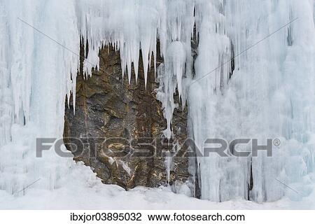 Stock Image - "Icicles in front of a rock face, Lofoten, Norway, Europe". Fotosearch