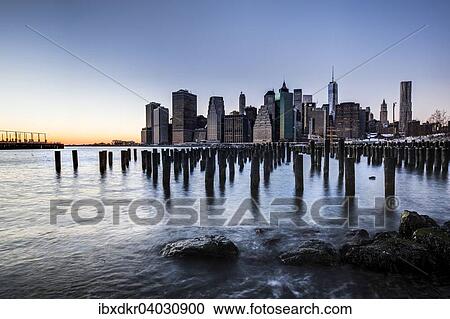 Stock Image - "ier at Brooklyn Bridge Park with view of the East River and the skyline of Manhattan, Brooklyn Heights, Brooklyn, New York, United States, North America". Fotosearch