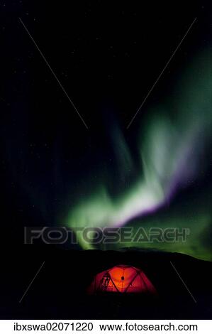"Illuminated expedition tent and traditional wooden snow shoes, Northern lights, Polar aurora or Aurora Borealis, green, pink, purple, near Whitehorse, Yukon Territory, Canada, North America" View Large Photo Image Stock Image - "Illuminated expedition tent and traditional wooden snow shoes, Northern lights, Polar aurora or Aurora Borealis, green, pink, purple, near Whitehorse, Yukon Territory, Canada, North America". Fotosearch