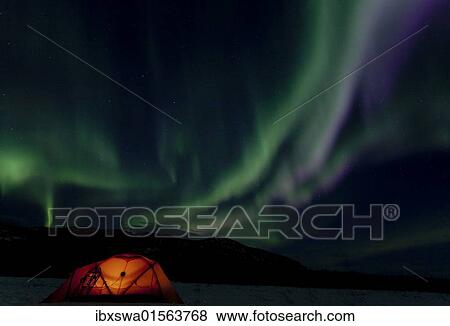 "Illuminated expedition tent and traditional wooden snow shoes, Northern or Polar Lights, Aurora Borealis, green, purple, blue, near Whitehorse, Yukon Territory, Canada, North America" View Large Photo Image Stock Photo - "Illuminated expedition tent and traditional wooden snow shoes, Northern or Polar Lights, Aurora Borealis, green, purple, blue, near Whitehorse, Yukon Territory, Canada, North America". Fotosearch