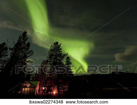 "Illuminated, lit wall tent, cabin with swirling northern polar lights, Aurora Borealis, green, near Whitehorse, Yukon Territory, Canada, North America" View Large Photo Image Stock Photo - "Illuminated, lit wall tent, cabin with swirling northern polar lights, Aurora Borealis, green, near Whitehorse, Yukon Territory, Canada, North America". Fotosearch