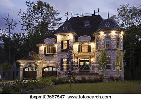 "Illuminated luxurious cottage-style residential house with two garages, Quebec Province, Canada, North America" View Large Photo Image Stock Photo - "Illuminated luxurious cottage-style residential house with two garages, Quebec Province, Canada, North America". Fotosearch