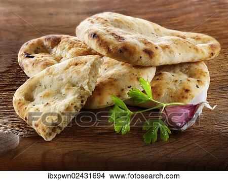 Indian naan bread with garlic and coriander View Large Photo Image Picture - Indian naan bread with garlic and coriander. Fotosearch