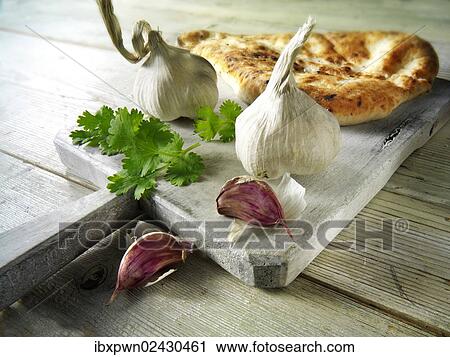 Indian naan bread with garlic and coriander View Large Photo Image Stock Image - Indian naan bread with garlic and coriander. Fotosearch