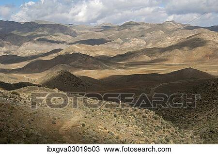 Stock Image - "Interplay of light and shadow on a hilly landscape, Richtersveld, Richtersveld Nationalpark, Northern Cape, South Africa, Africa". Fotosearch