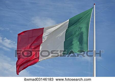 Stock Image - Italian flag against blue sky. Fotosearch