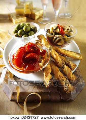 "Italian Party buffet food with dried tomatoes, bread sticks or bread sticks, olives and marinated wild mushrooms" View Large Photo Image Stock Photo - "Italian Party buffet food with dried tomatoes, bread sticks or bread sticks, olives and marinated wild mushrooms". Fotosearch