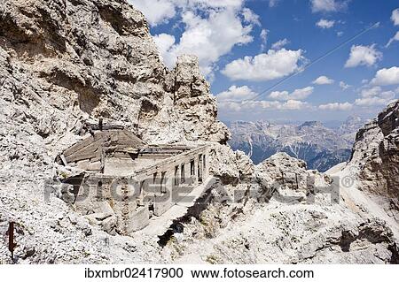 Stock Image - "Ivano Dibona fixed rope route, here on Monte Cristallo mountain, on the way to the summit of Monte Cristallino above Cortina, derelict ruins of a military post on the left, Belluno, Dolomites, Italy, Europe". Fotosearch