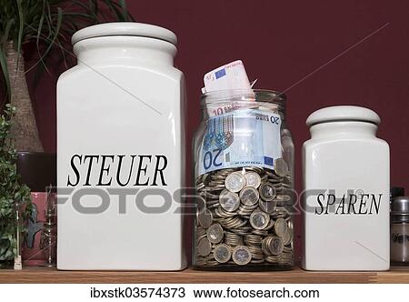 "Jar containing money and jars with the signs """"Steuer"""" and """"Sparen"""", German for """"taxes"""" and """"savings"""", on a kitchen shelf, Germany, Europe" View Large Photo Image Stock Image - "Jar containing money and jars with the signs """"Steuer"""" and """"Sparen"""", German for """"taxes"""" and """"savings"""", on a kitchen shelf, Germany, Europe". Fotosearch