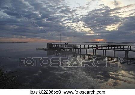 "Jetty at Federsee lake, clouds, reflections, Federsee lake nature reserve, morning mood, Baden-Wuerttemberg, Germany, Europe" View Large Photo Image Stock Image - "Jetty at Federsee lake, clouds, reflections, Federsee lake nature reserve, morning mood, Baden-Wuerttemberg, Germany, Europe". Fotosearch