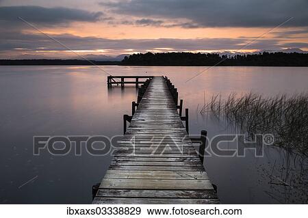 Stock Photo - "Jetty at Lake Mahinapua at sunrise, Ruatapu, West Coast Region, New Zealand, Oceania". Fotosearch