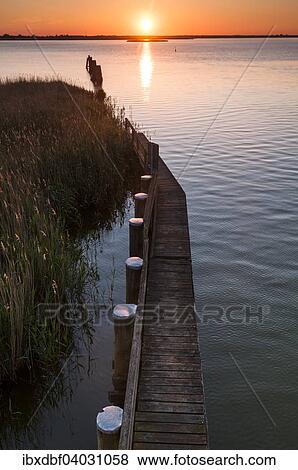 "Jetty in the Bodden, shallow lagoon, sunset, Baltic, Zingst, Fischland-Darss-Zingst, Mecklenburg-Western Pomerania, Germany, Europe" View Large Photo Image Stock Photo - "Jetty in the Bodden, shallow lagoon, sunset, Baltic, Zingst, Fischland-Darss-Zingst, Mecklenburg-Western Pomerania, Germany, Europe". Fotosearch
