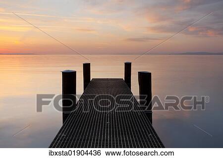 "Jetty in the evening light overlooking Lake Constance near Bregenz, Rohrspitz, Austria, Europe" View Large Photo Image Stock Photograph - "Jetty in the evening light overlooking Lake Constance near Bregenz, Rohrspitz, Austria, Europe". Fotosearch