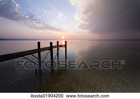 "Jetty with evening light and stormy atmosphere overlooking Lake Constance near Bregenz, Rohrspitz, Austria, Europe" View Large Photo Image Stock Image - "Jetty with evening light and stormy atmosphere overlooking Lake Constance near Bregenz, Rohrspitz, Austria, Europe". Fotosearch